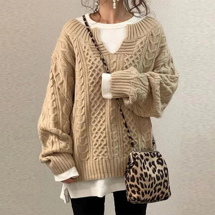 Oversized knit sweater with cable pattern