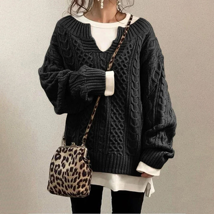 Oversized knit sweater with cable pattern